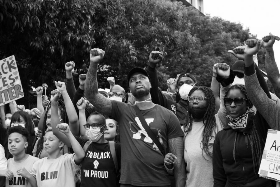 Damian Lillard of the Portland Trailblazers (center) with protestors in Portland, Oregon.