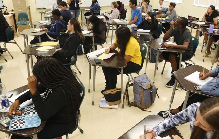 Seniors at Jupiter High School take notes during math class