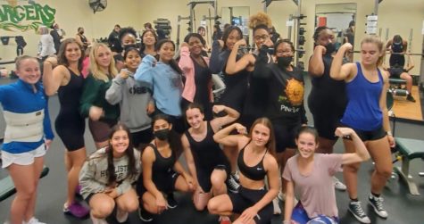 The Suncoast Wrestling Team poses for a group photo in the weight room. 
