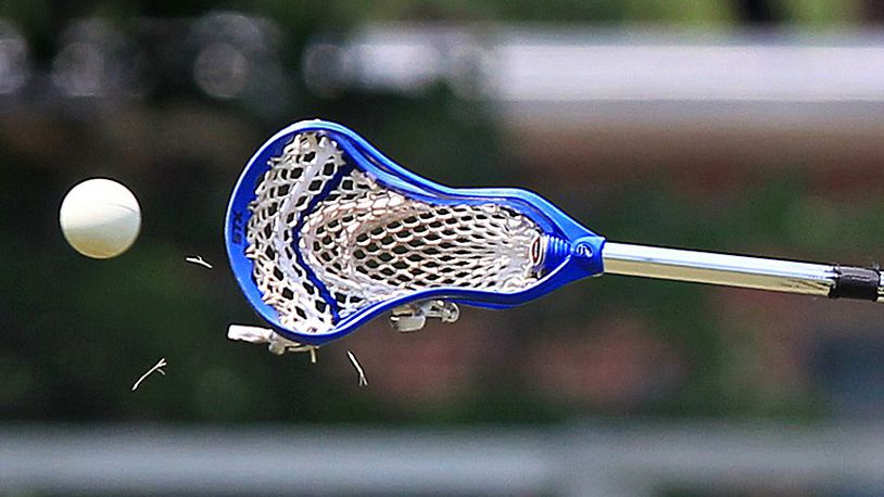 A lacrosse stick catches a ball mid-game.